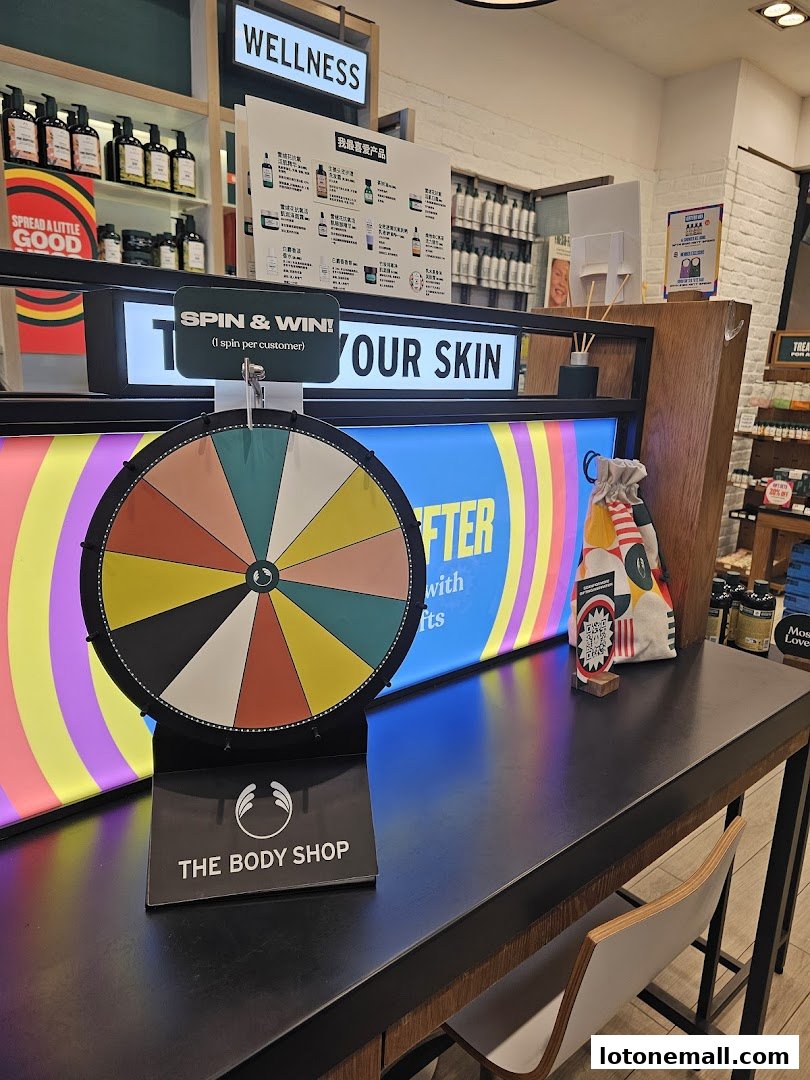The Body Shop store interior featuring a spin-to-win game and product displays.