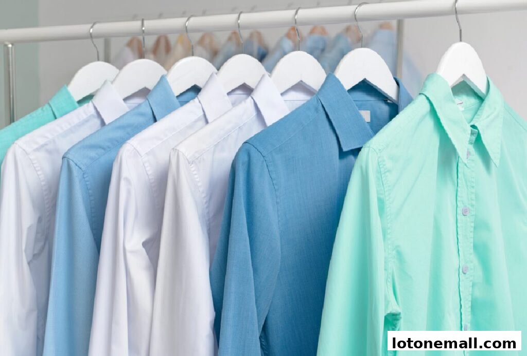 A row of neatly hung shirts in various pastel colors, including mint green and light blue.