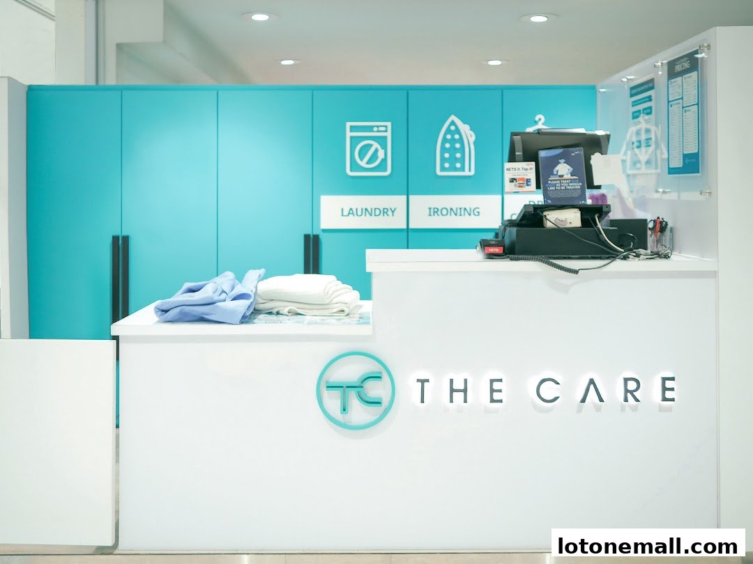 The Care Laundry Lot One shop counter with folded clothes and a pricing chart.