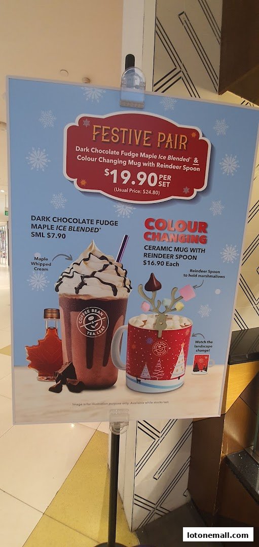 A promotional sign for The Coffee Bean & Tea Leaf featuring a festive drink and mug set.