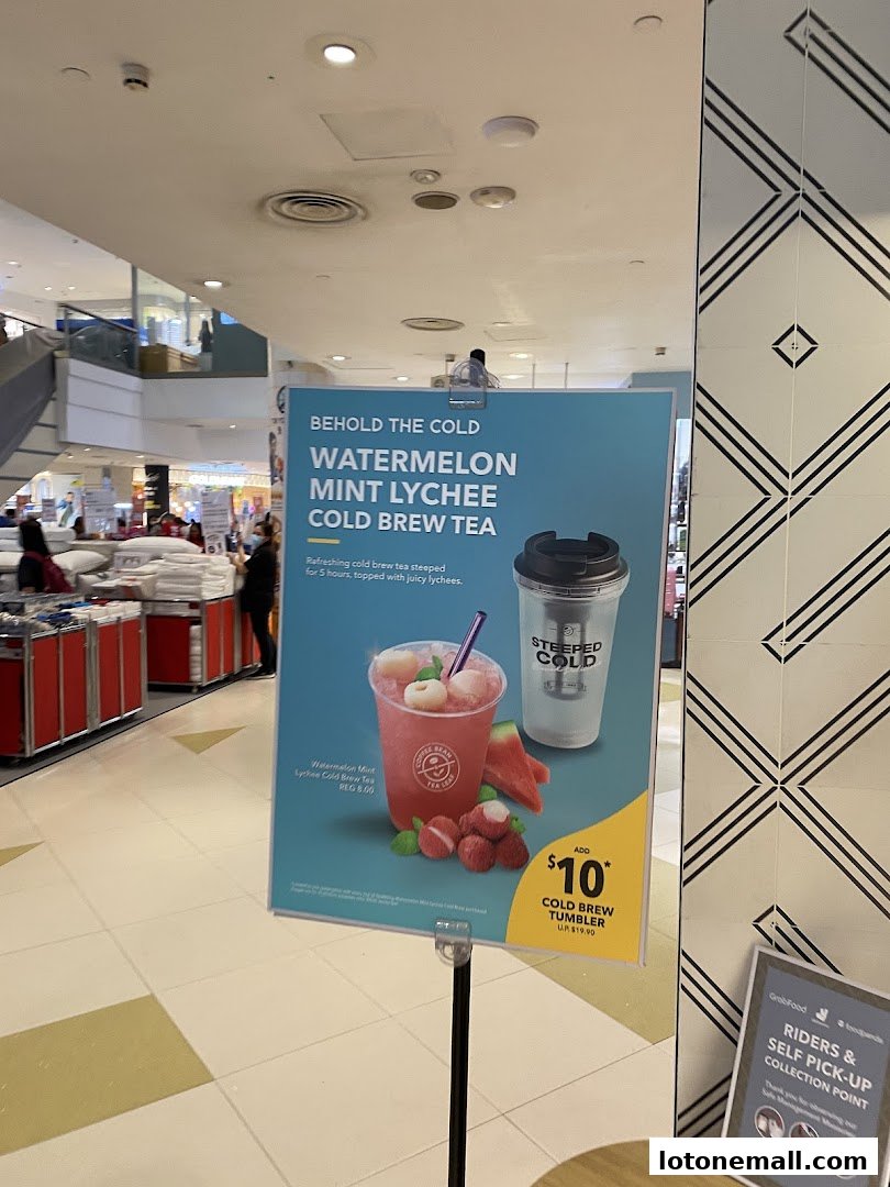 A sign advertising The Coffee Bean & Tea Leaf's Watermelon Mint Lychee Cold Brew Tea.