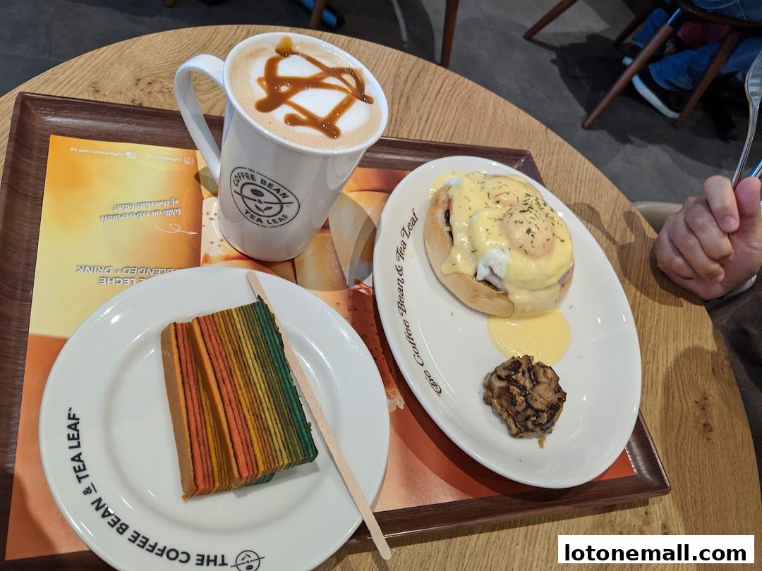 A tray with a caramel latte, rainbow cake, and eggs benedict from The Coffee Bean & Tea Leaf.