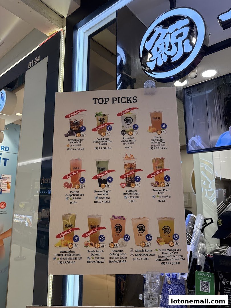 A menu board displaying 'Top Picks' of various flavored teas and drinks from The Whale Tea.