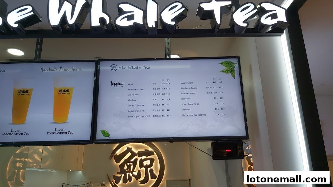 A digital menu board displaying drinks and toppings for The Whale Tea.