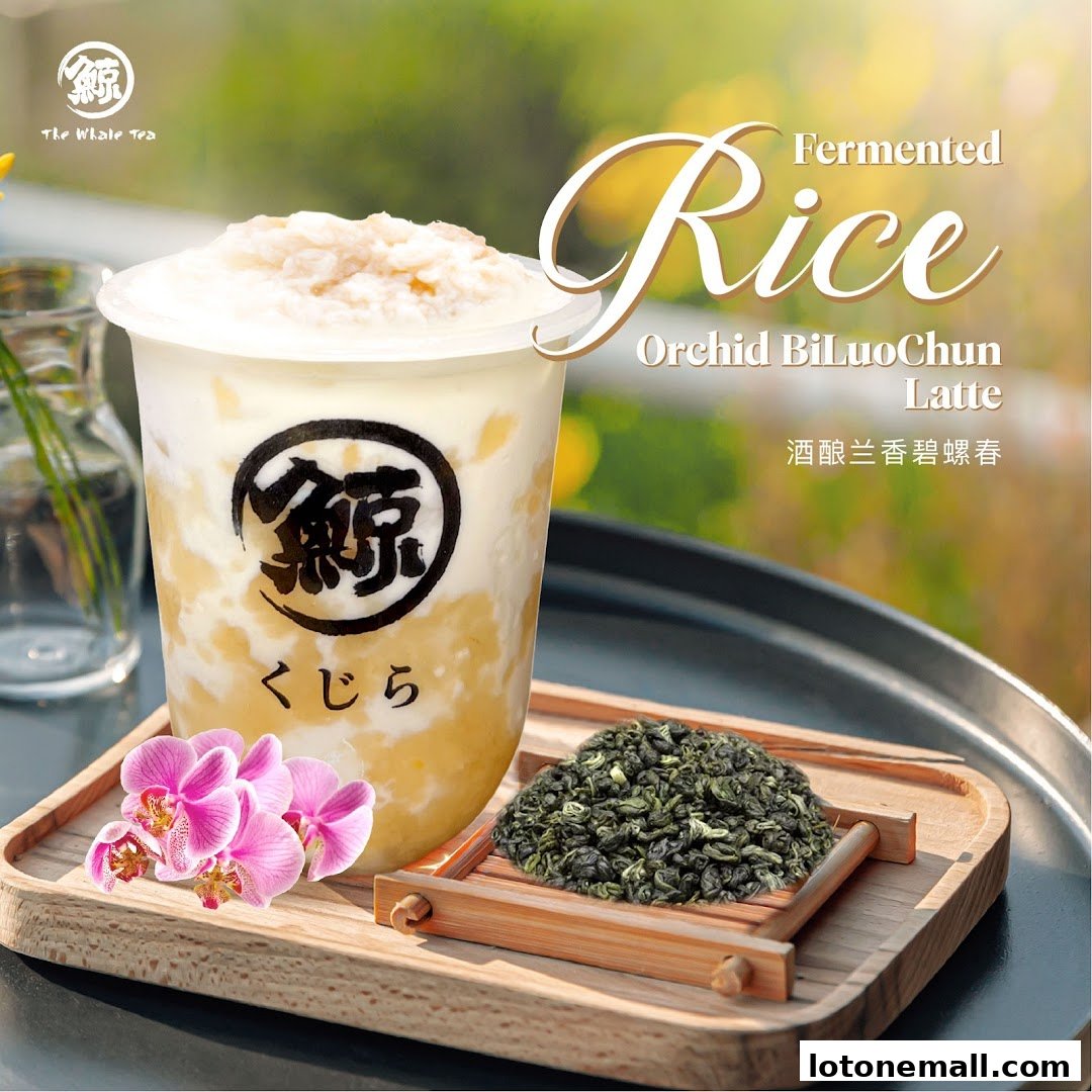 A refreshing Fermented Rice Orchid BiLuochun Latte with orchids and tea leaves.