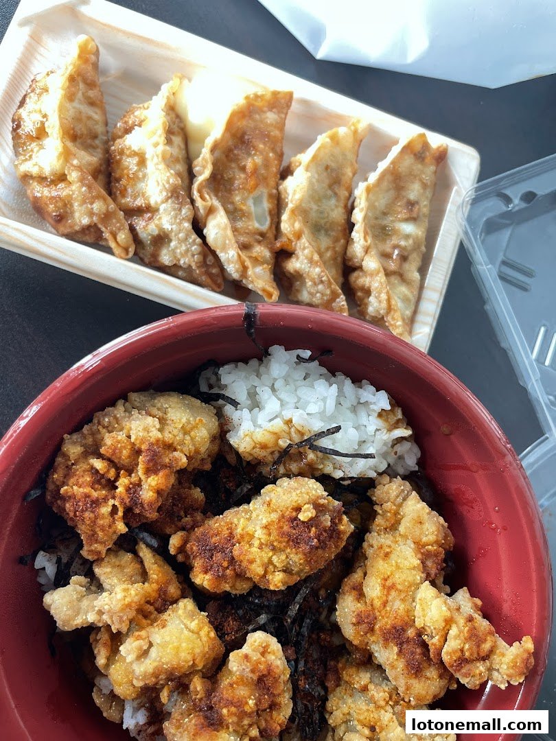 A close-up of Japanese street food, featuring crispy fried chicken and pan-fried dumplings.