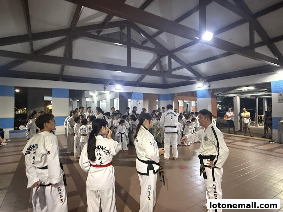 A group of people in Taekwondo uniforms gathered for a class or demonstration.