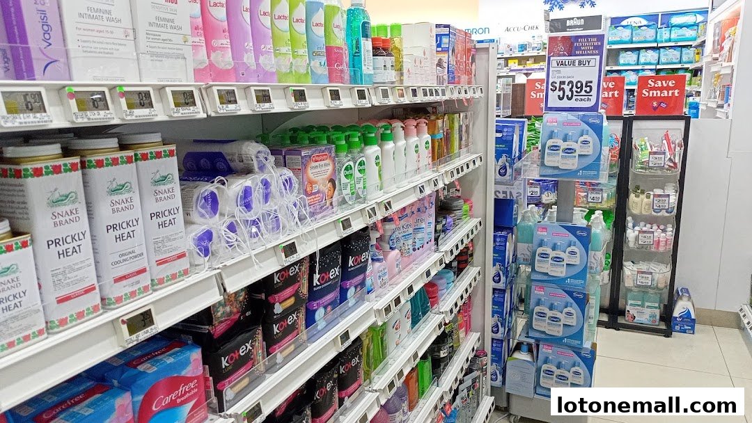 Shelves stocked with personal care products, including feminine wash, prickly heat powder, and lotions.