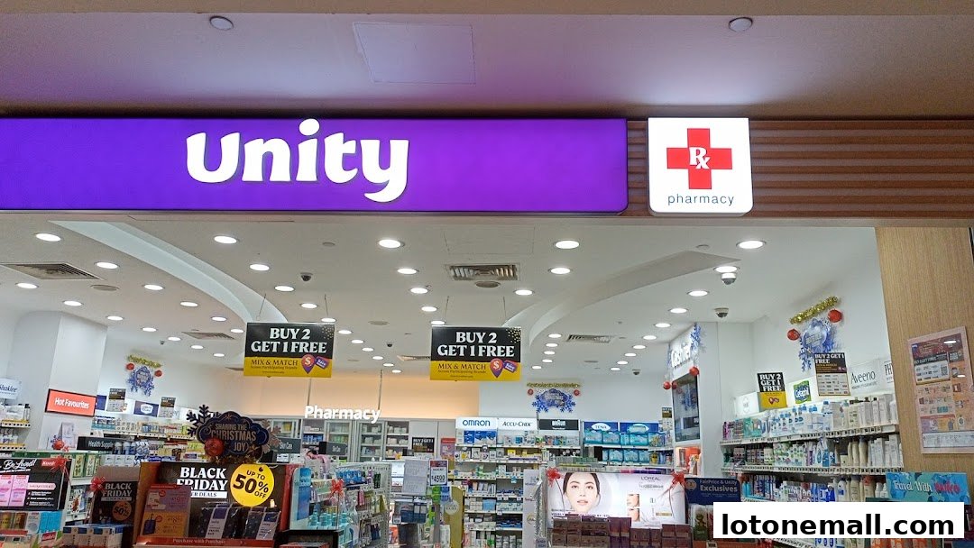 The entrance of a Unity pharmacy store with promotional signs and shelves stocked with products.