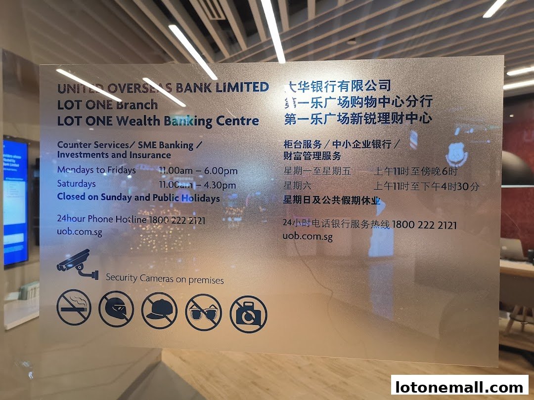 Signage for UOB Lot One Branch Wealth Banking Centre with operating hours and services.