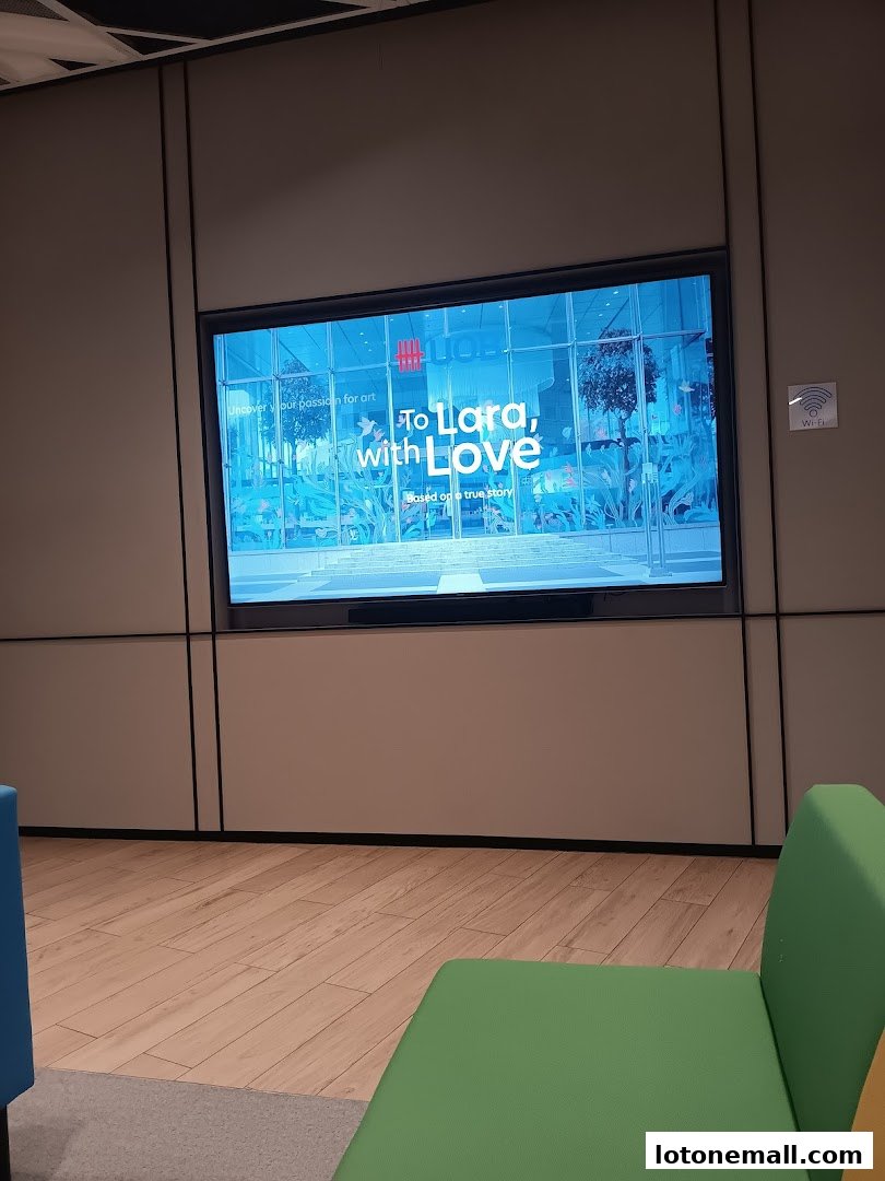 A digital screen displays "To Lara, with Love" and "Uncover your passion for art."