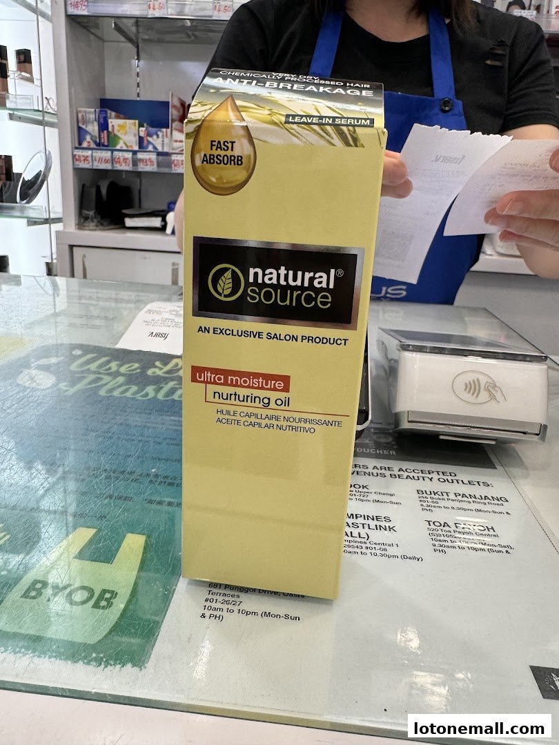 A box of Natural Source Ultra Moisture Nurturing Oil is displayed at a counter.