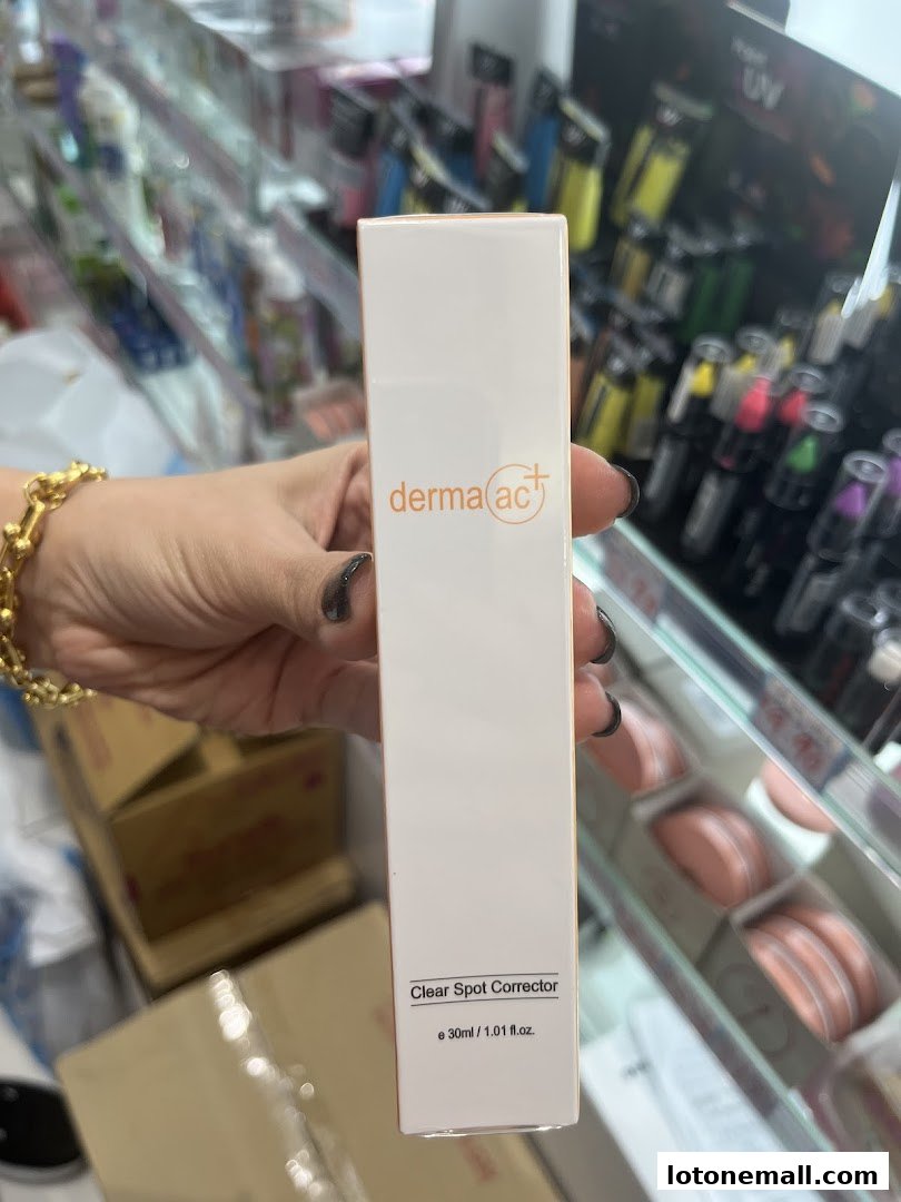 A hand holds a box of Derma-ac+ Clear Spot Corrector in a beauty store.