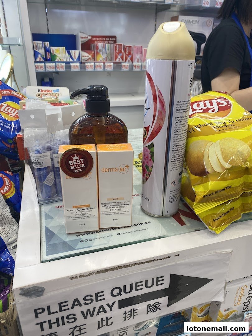A counter display in a shop featuring skincare products, snacks, and an air freshener.