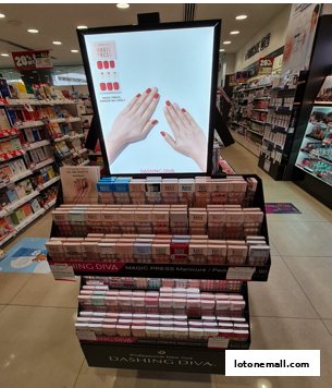 A display stand featuring Dashing Diva Magic Press Manicure products in a Watsons store.