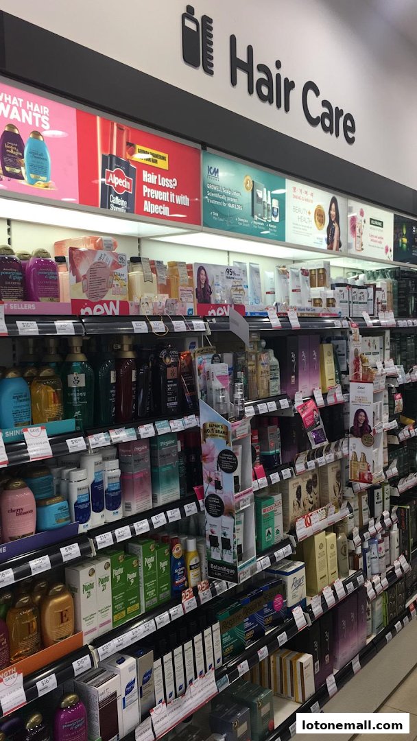 A wide selection of hair care products displayed on shelves in a retail store.