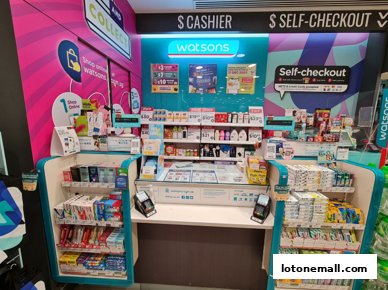 Watsons Singapore GNC store with cashier and self-checkout counters, stocked with health and beauty products.