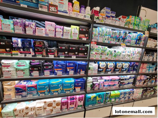 Shelves stocked with various sanitary pads and feminine hygiene products.