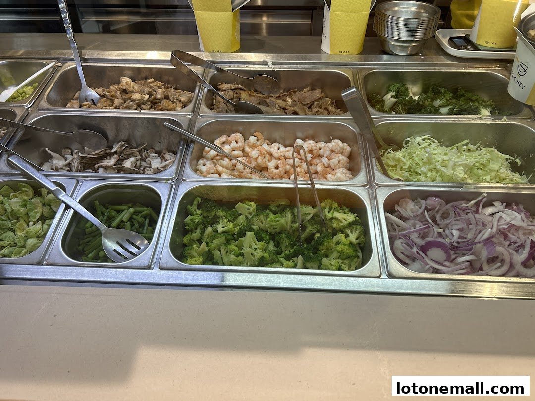 A display of fresh ingredients including meats, seafood, and vegetables for customizable meals.