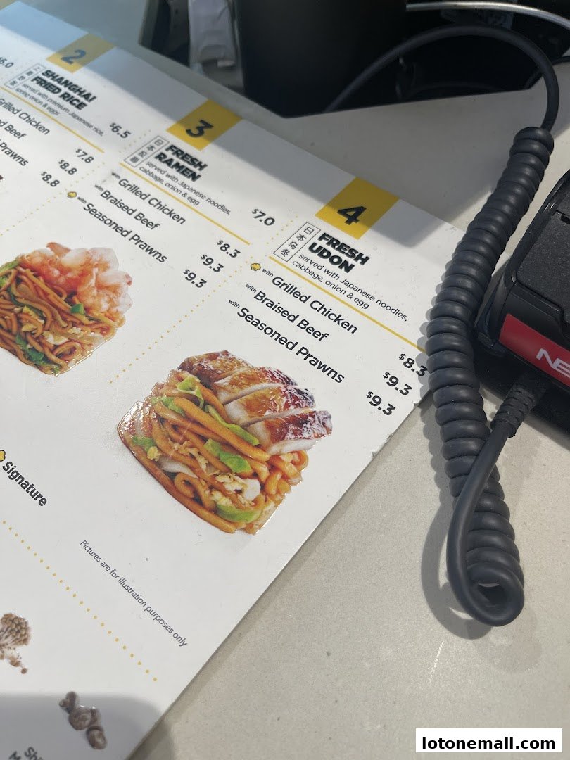 A close-up view of a Wok Hey menu showcasing various noodle and rice dishes with prices.