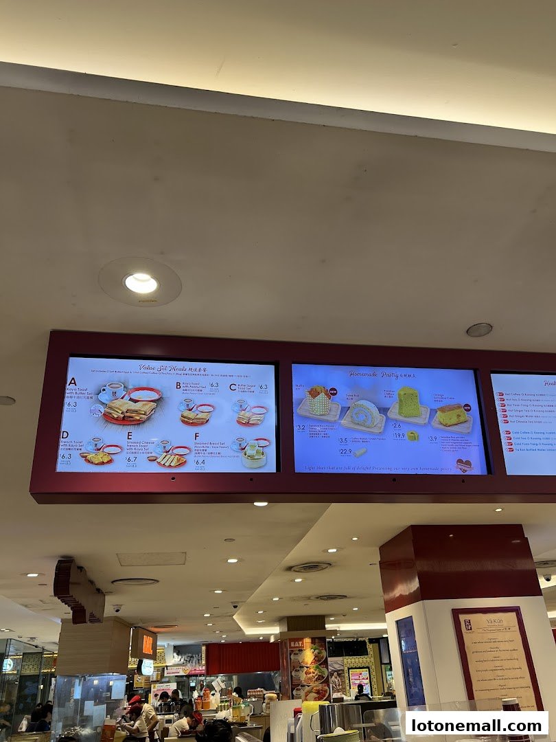 Digital menu boards displaying set meals and homemade pastries at Ya Kun Kaya Toast.
