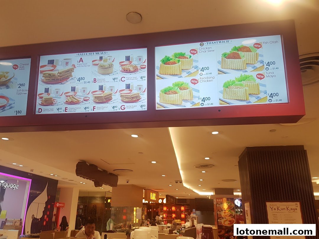 A digital menu board displaying various set meals and toastwiches from Ya Kun Kaya Toast.