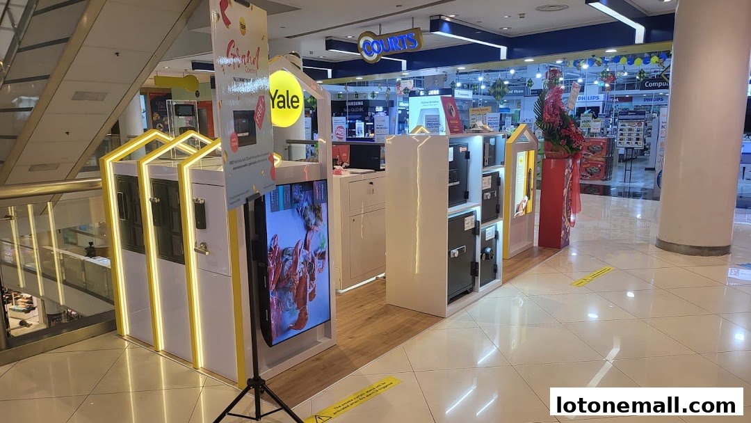A Yale Smart Shop display featuring safes and a promotional screen in a shopping mall.