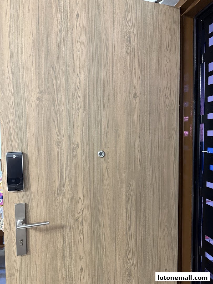 A close-up of a modern wooden door with a smart lock and handle.