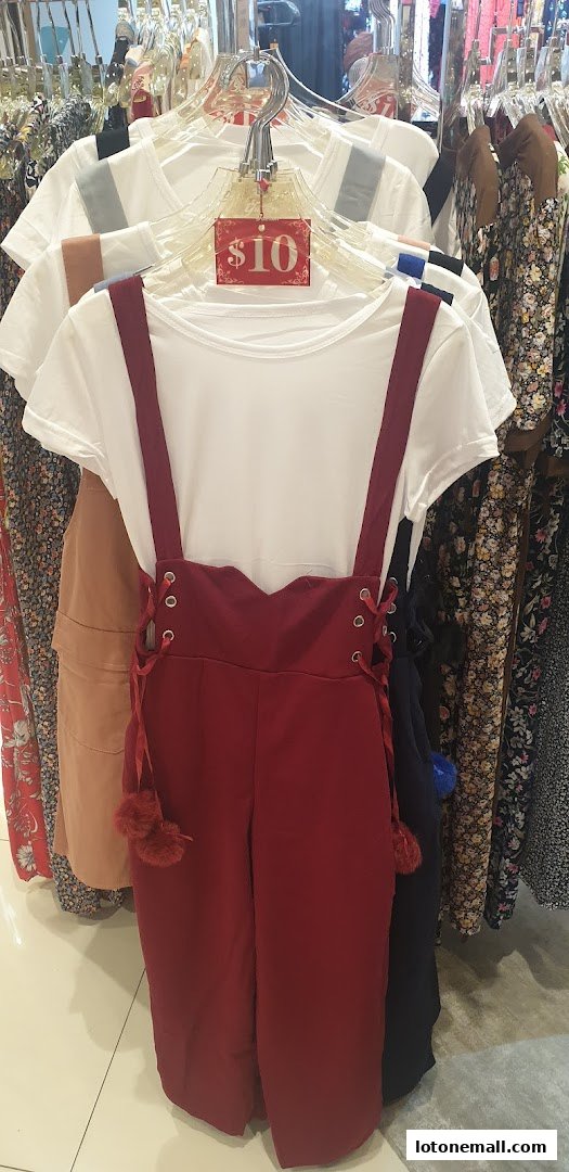 A red jumpsuit with a white t-shirt and a $10 price tag displayed on hangers.