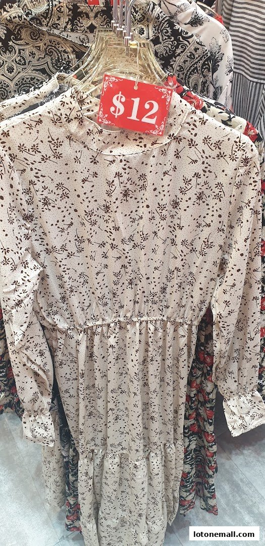A light-colored dress with a floral pattern and a $12 price tag.
