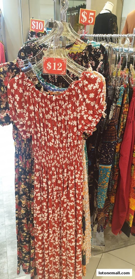 A rack of colorful floral print dresses with price tags indicating $5, $10, and $12.