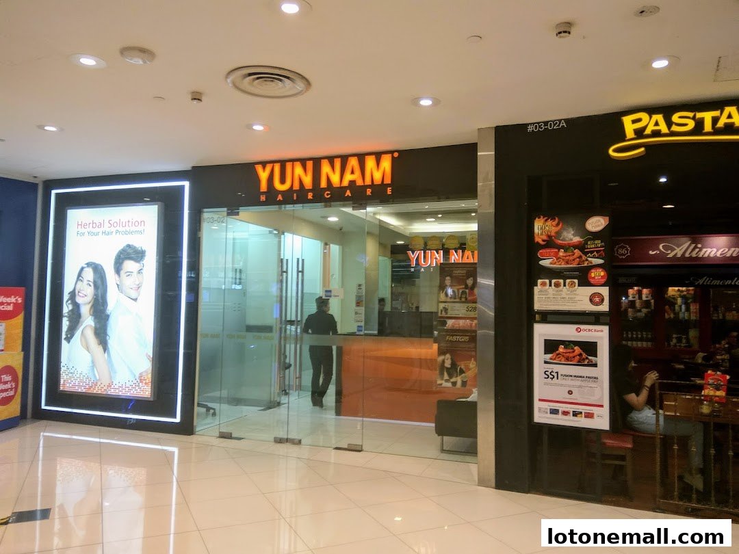 The entrance of Yun Nam Hair Care, a salon offering herbal hair solutions, next to a pasta restaurant.