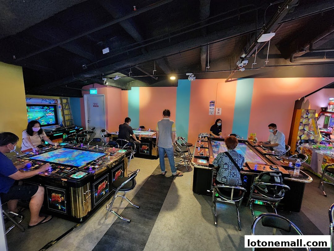 People playing arcade games in a brightly lit entertainment center.