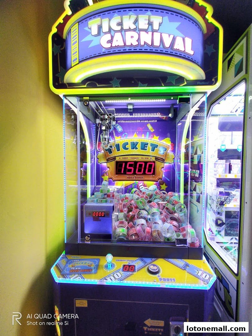 A brightly lit 'Ticket Carnival' arcade game machine filled with prize tickets.