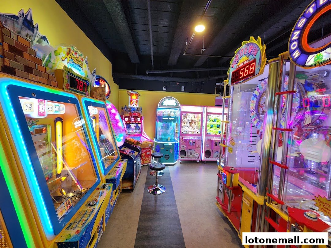 An arcade with colorful game machines, including claw machines and ticket redemption games.