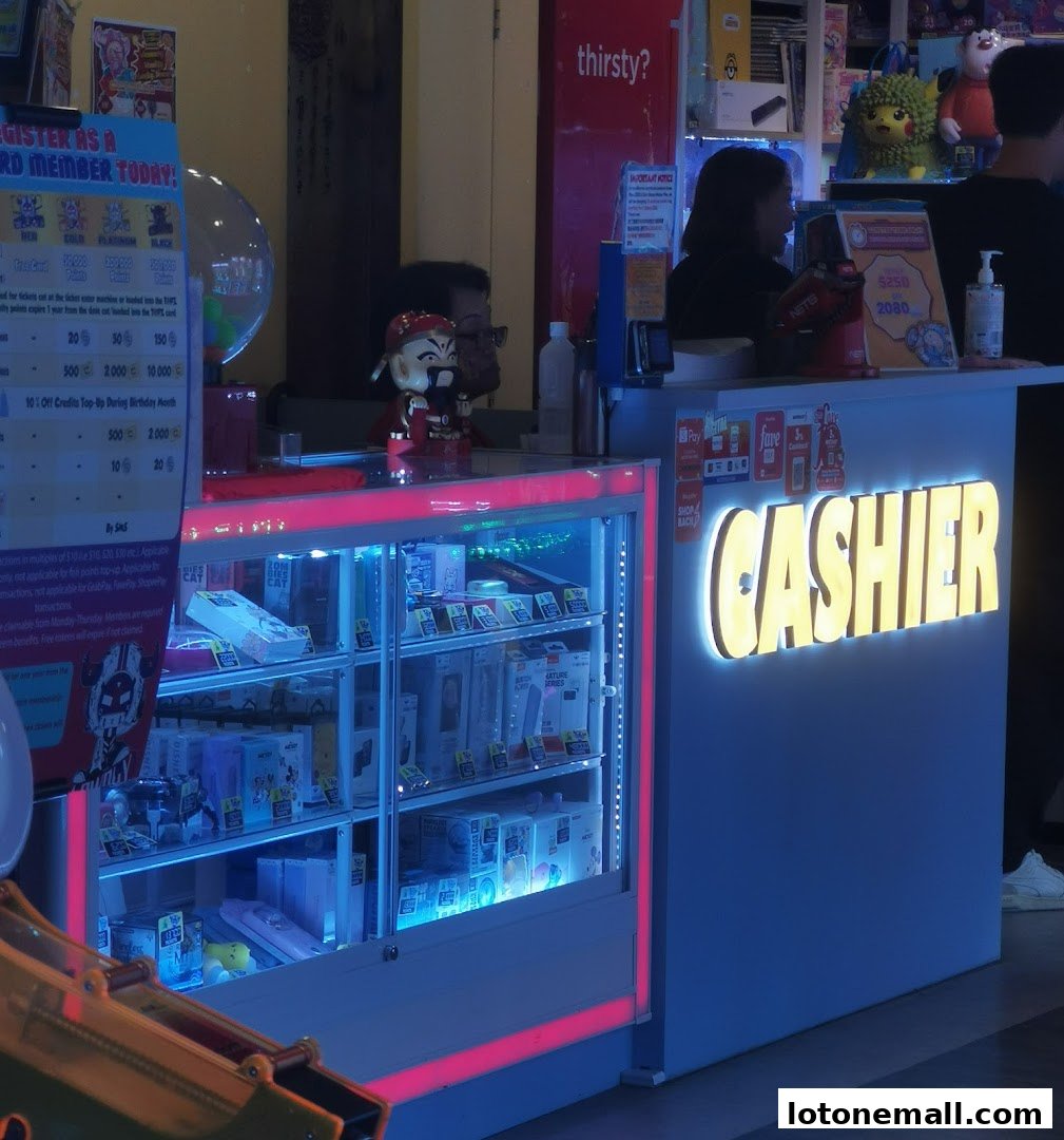 A brightly lit cashier counter with merchandise displayed in a glass cabinet.