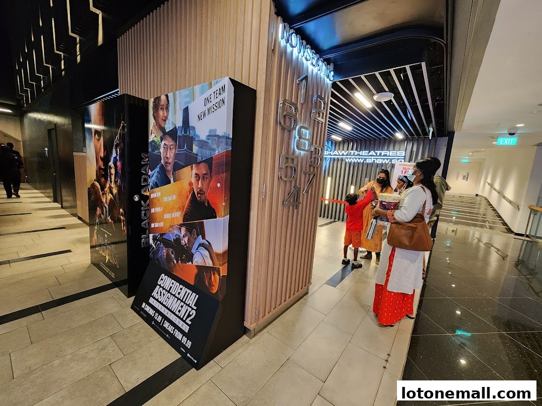 People gather near movie posters and signage at Shaw Theatres.