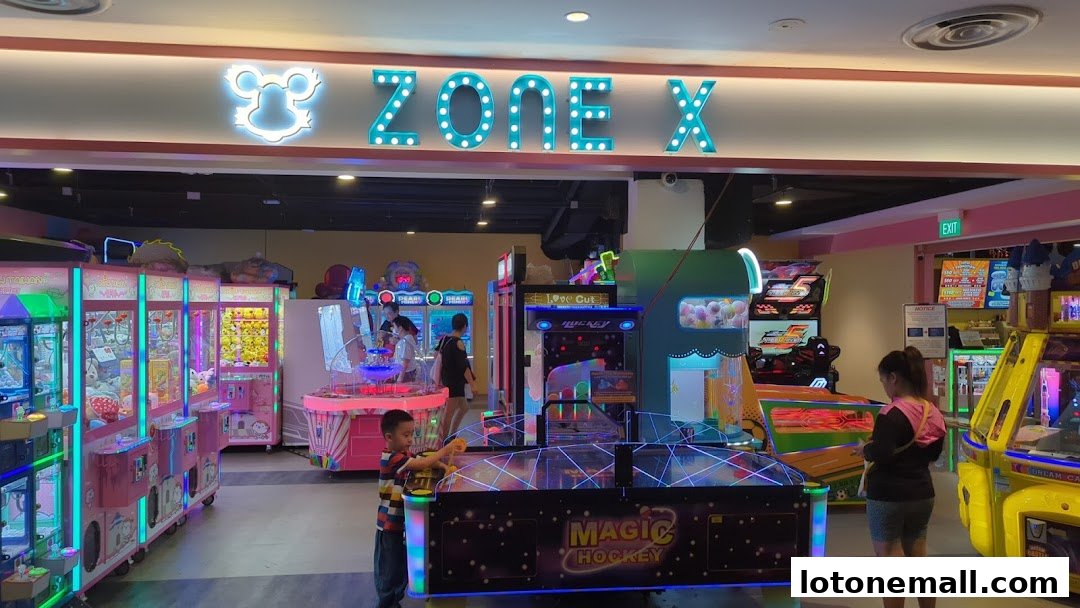 Interior of an arcade with various game machines and people playing.
